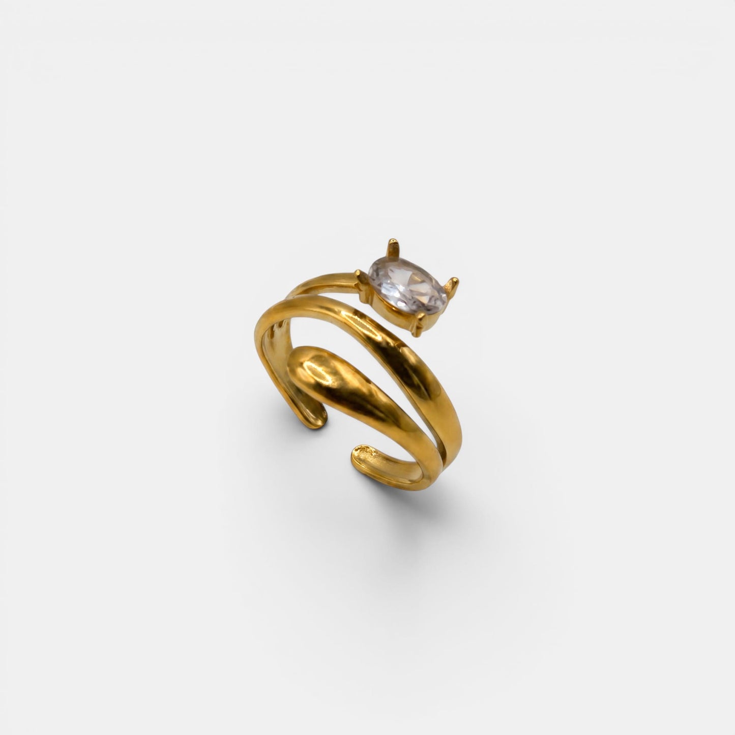 Goldener Lumina Bypass-Ring mit einem großen, funkelnden Solitär-Kristallstein im Zentrum.